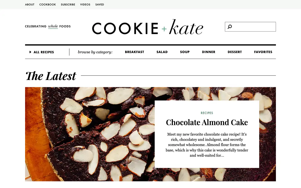 Cookie and Kate homepage: serif and script logo, a category bar and a full-width chocolate almond cake photo with a text card