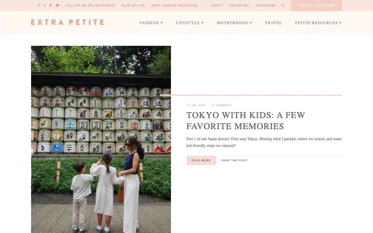 Extra Petite homepage: pink top bar with shop links, a spaced pink wordmark and a Tokyo travel post with a tall photo