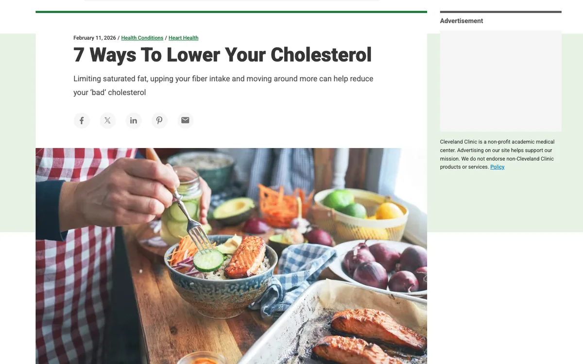 Cleveland Clinic listicle: headline “7 Ways To Lower Your Cholesterol”, a one-line subhead and a photo of a salmon salad on a table